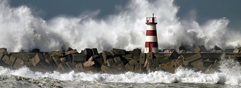 Waves crashing over a storm break