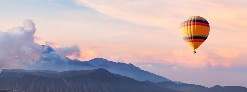 beautiful inspirational landscape with hot air balloon flying in the sky