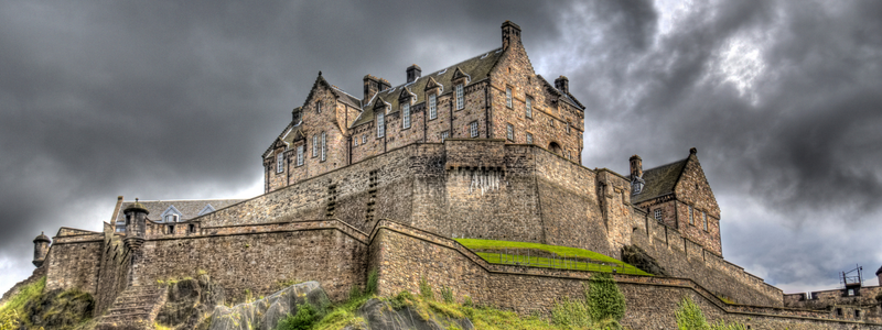 Edinburgh Castle with dark clouds above it