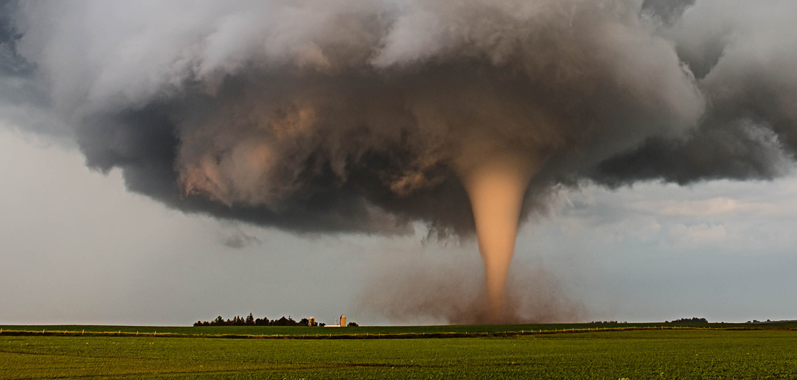 A tornado churns up dust in the sunset light near Traer, Iowa by Brad Goddard, Orion, IL Image credit NOAA