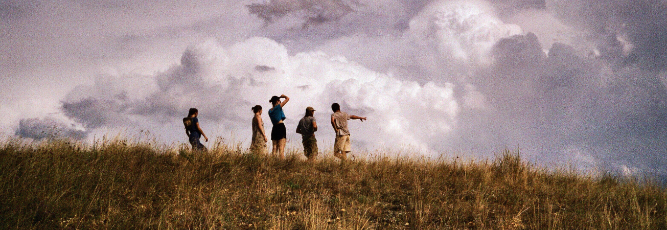 A group of weather enthusiasts looking out from a hilltop