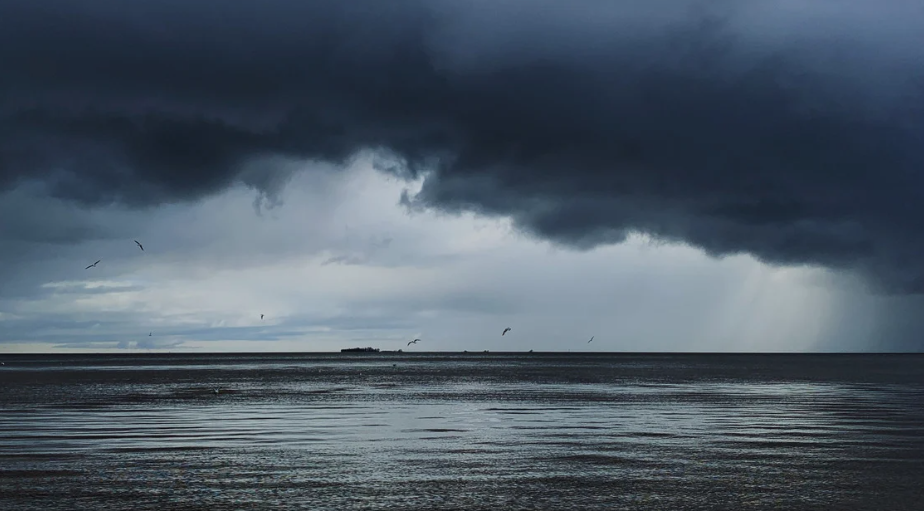 Storm over the sea, with the front cover of The International Journal Of Climatology
