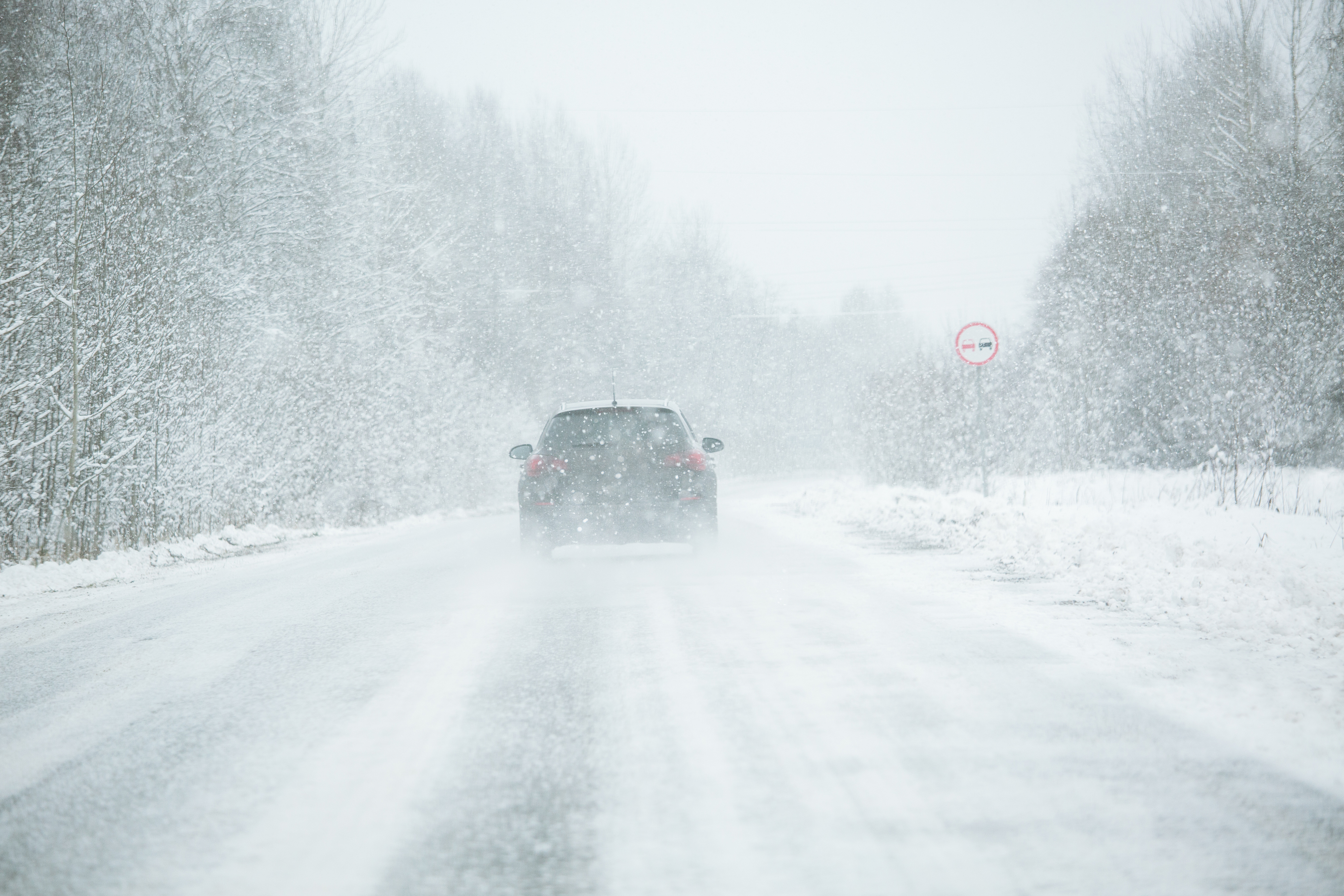 Car driving in a blizzard