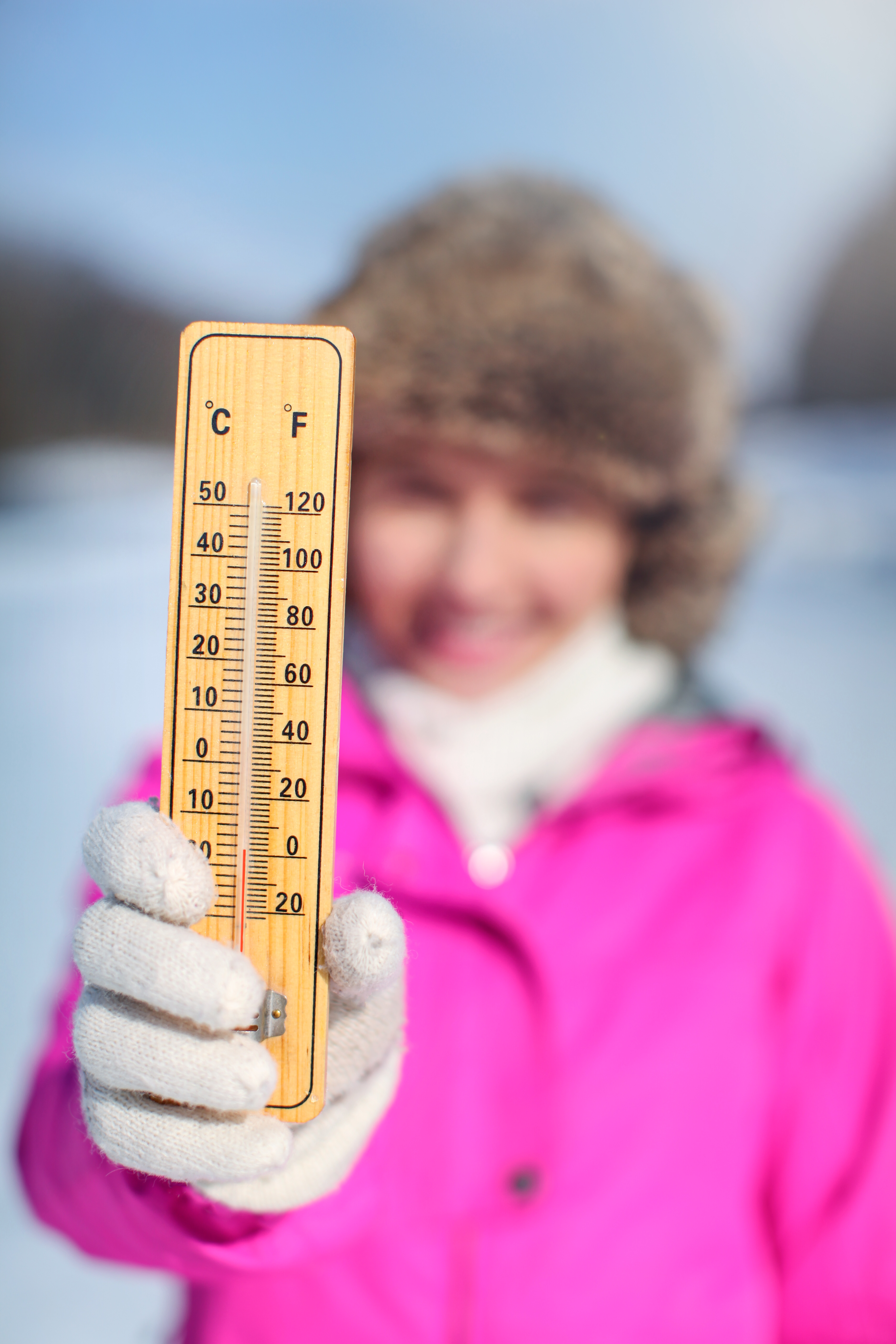 Women holding up a thermometer