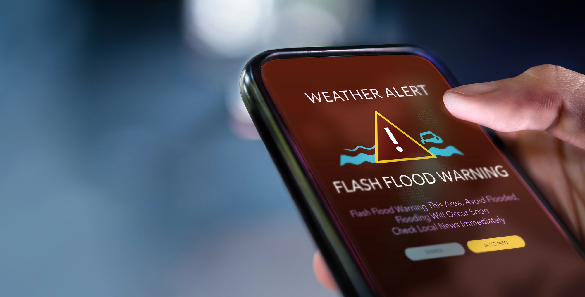 A mobile phone shows a weather alert
