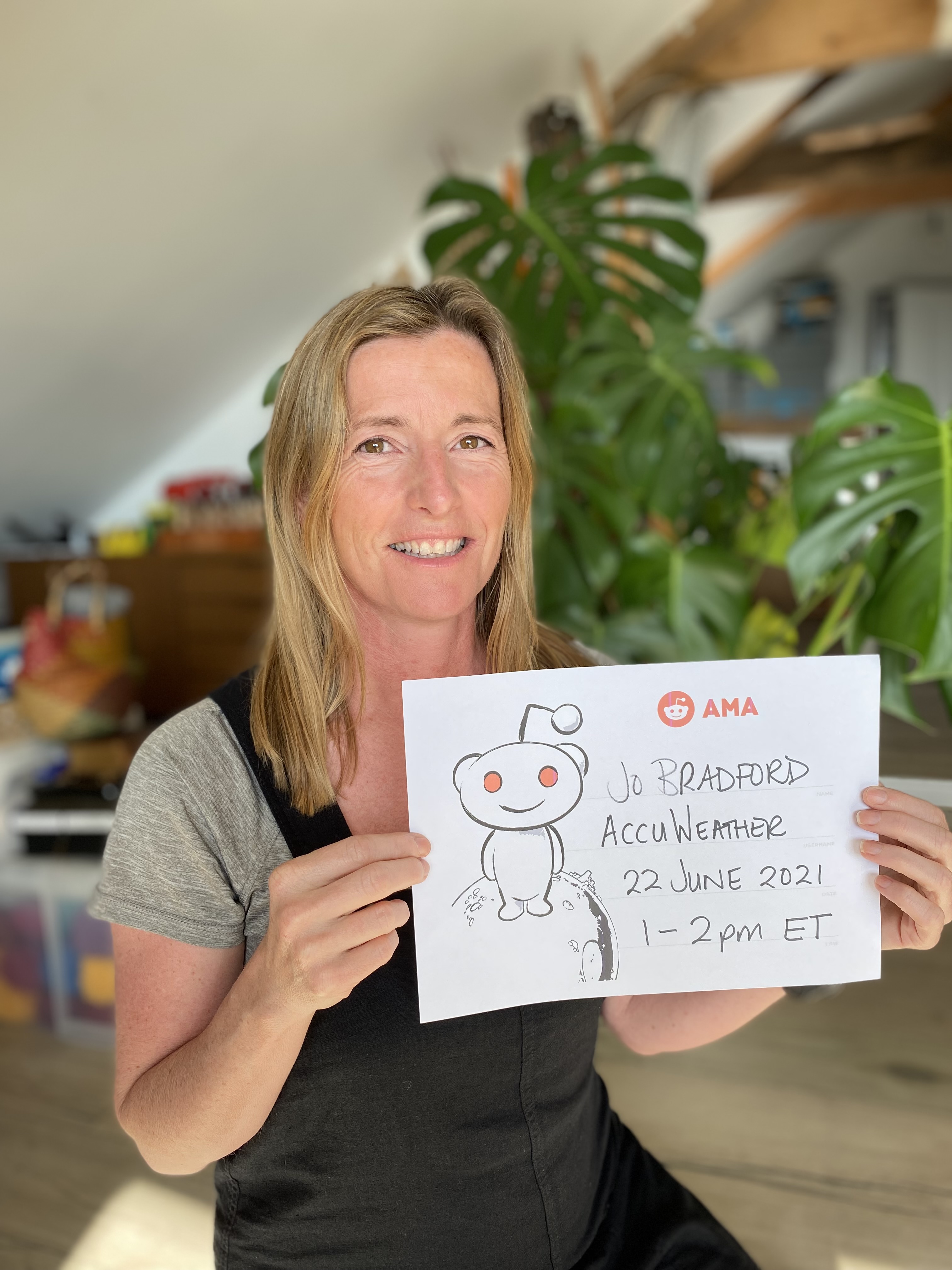 Jo Bradford holding a sign with the time and date of the Reddit event