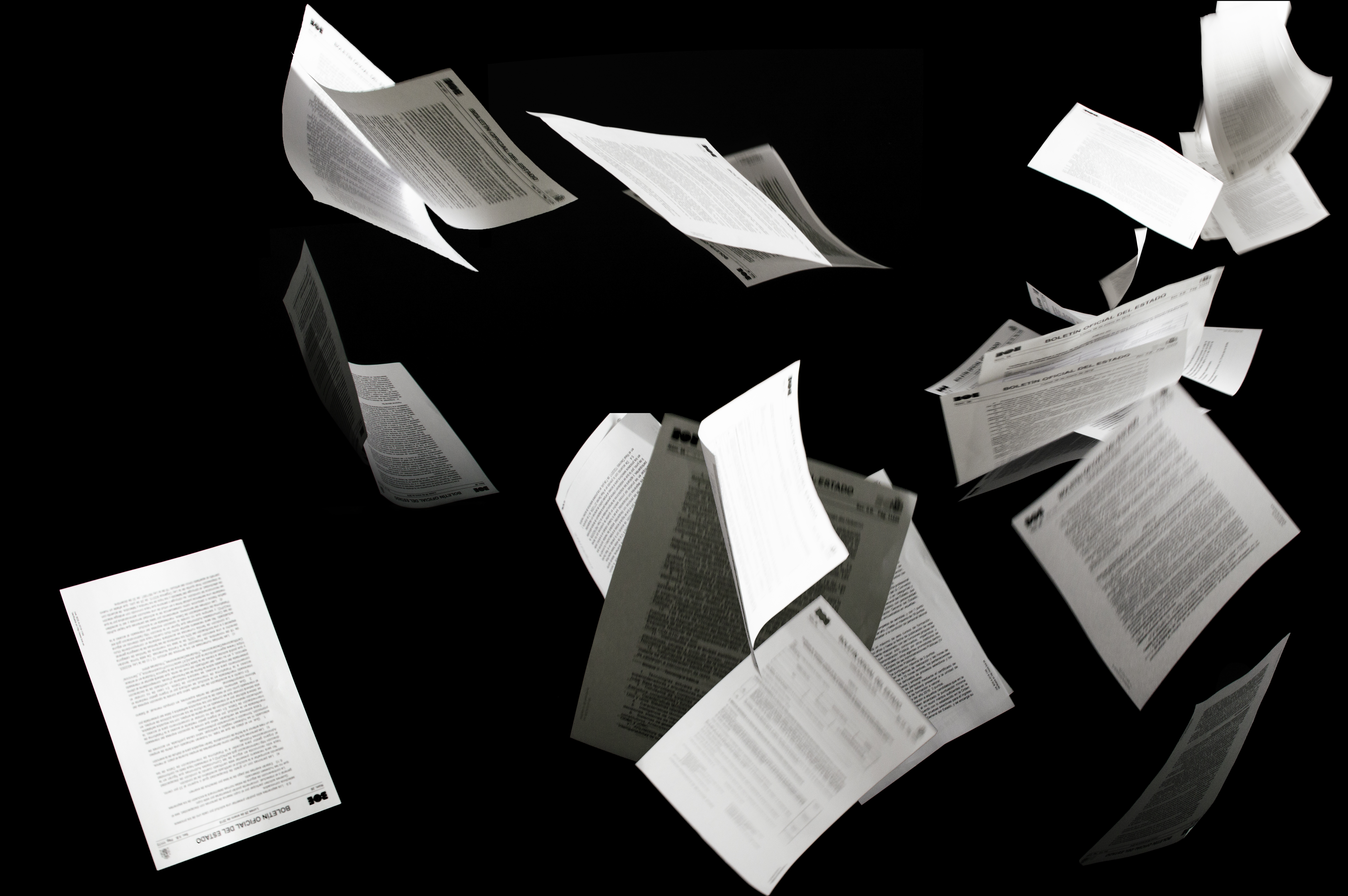 Papers flying on black background