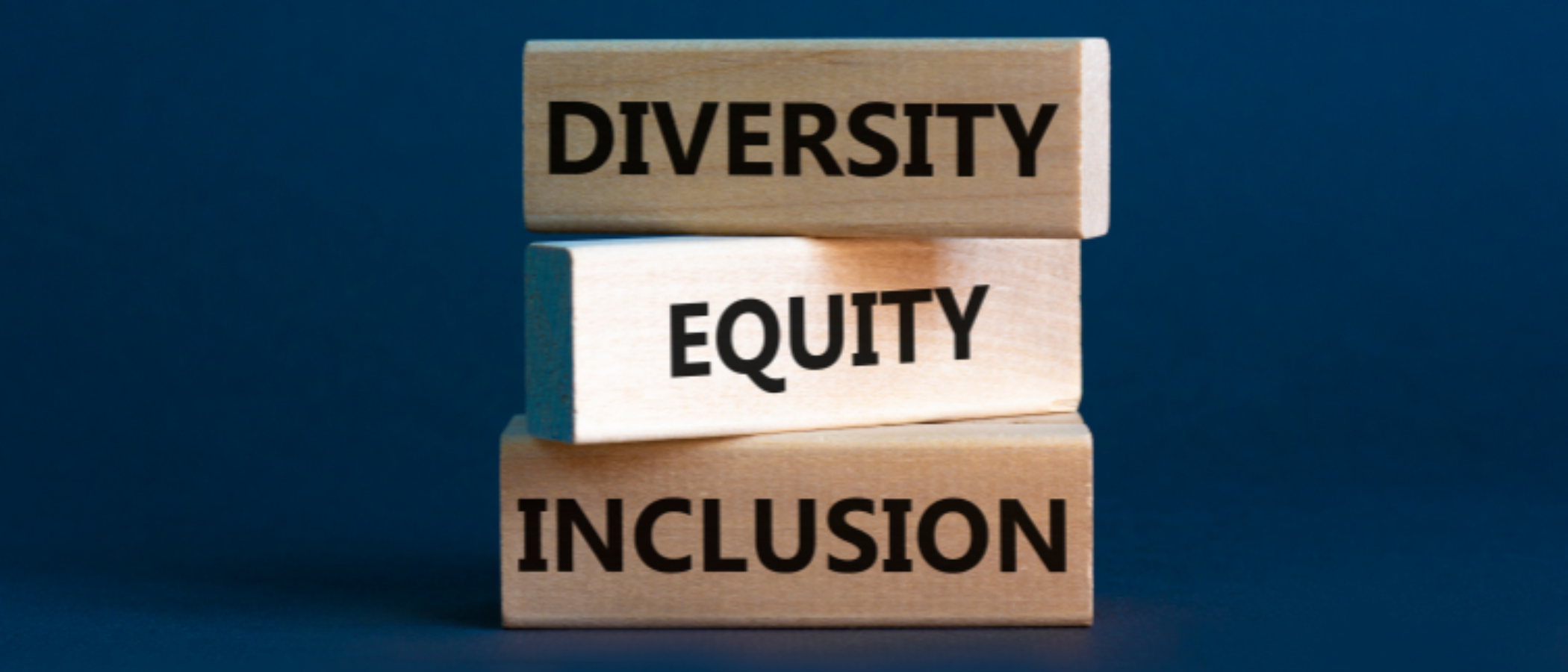 3 stacked wooden blocks with the words Diversity, Equity and Inclusion
