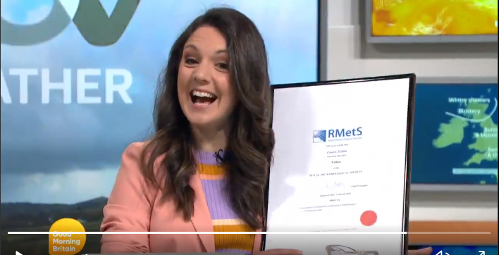 Laura Tobin smiling with her Fellow certificate