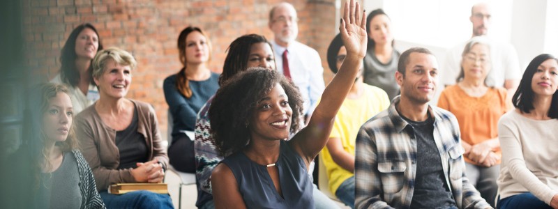 An audience with hands up