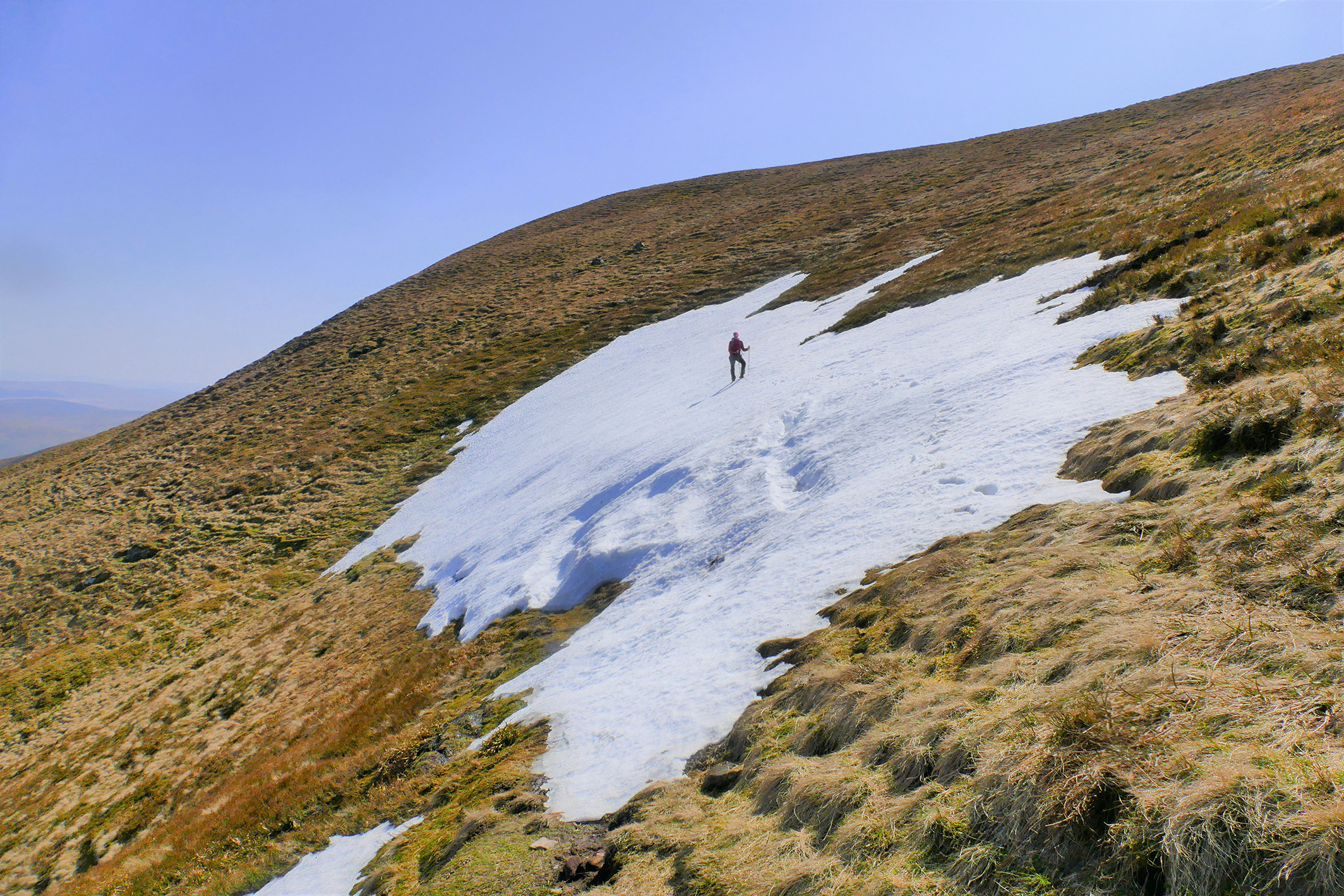 Author Iain Cameron stands on the last patch of snow south of the Central Belt, at Cramalt Craig on 22 April 2019. On this date, it was 50m long. (© Iain Cameron.)