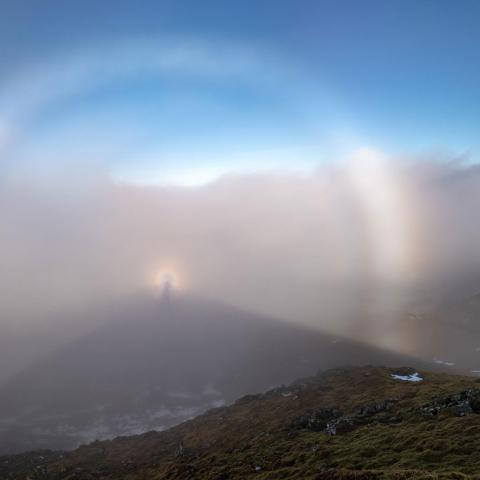A panoramic shot from Meall Nan Tarmachan in fog with a fog bow and Broken Spectre