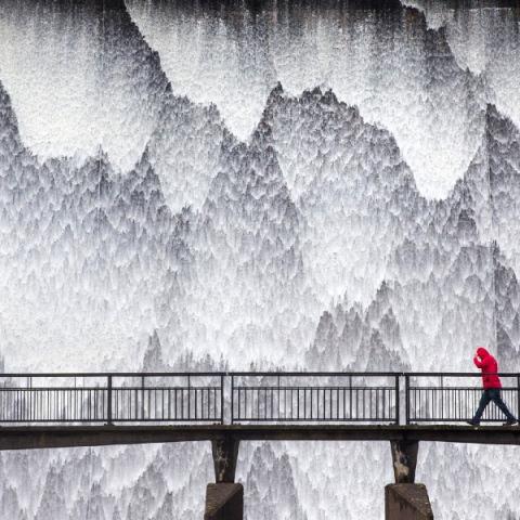 Water cascades down the dam wall of Wet Sleddale reservoir near Shap in Cumbria