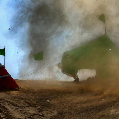 A small tornado enters the tents of a number of villagers and lifts them into the sky