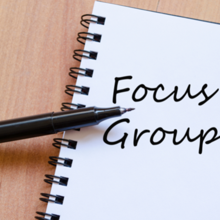 A note pad and pen with the writing saying Focus Groups