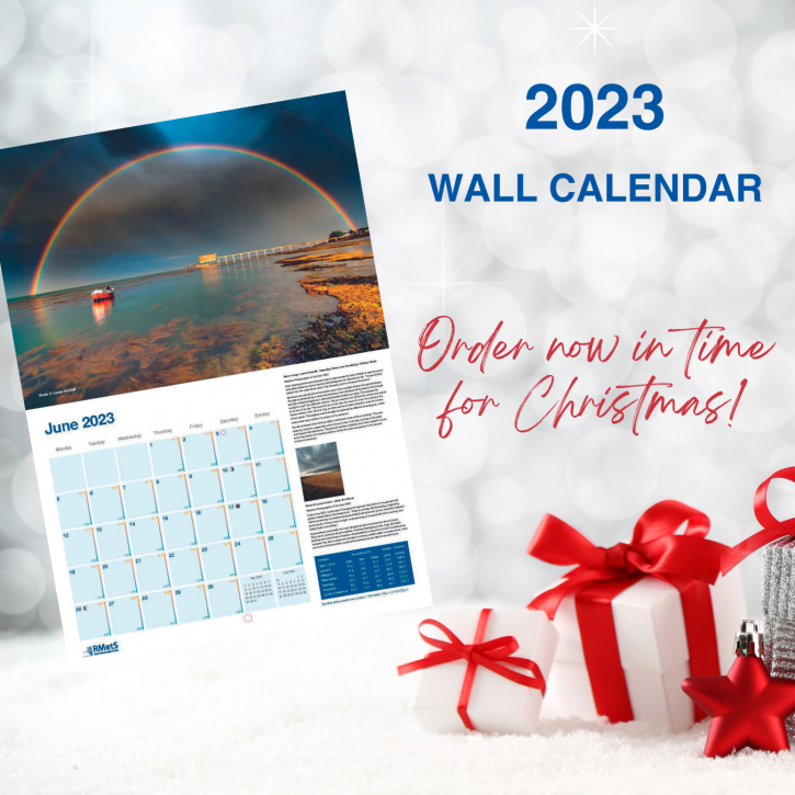 June's image and calendar grid of a rainbow over Bembridge Lifeboat Station on a white christmassy background with presents and the text 2023 Wall Calendar, Order now in time for Christmas!