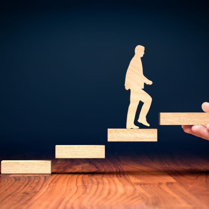 A figure steps up some stairs