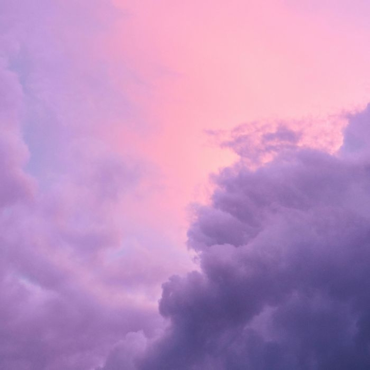 Clouds drift across a purple sky
