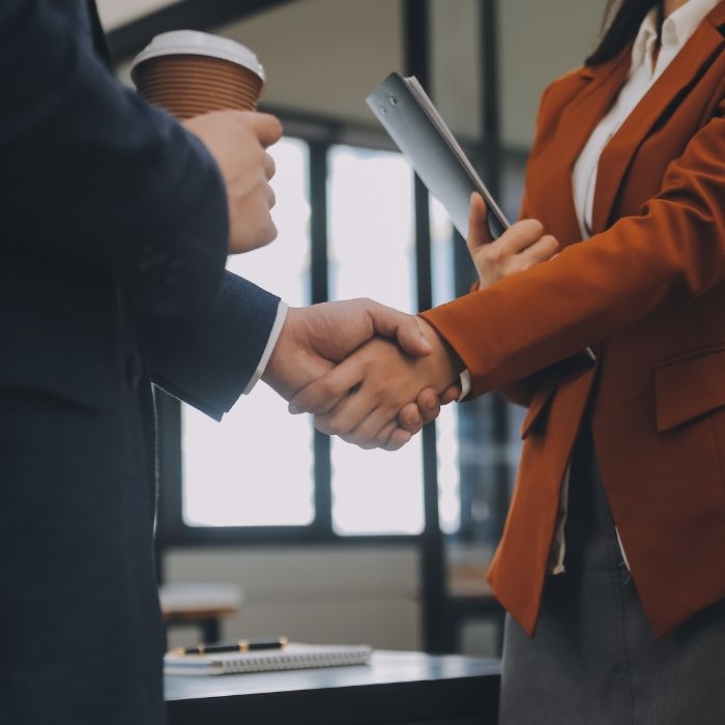 A man and a woman shake hands