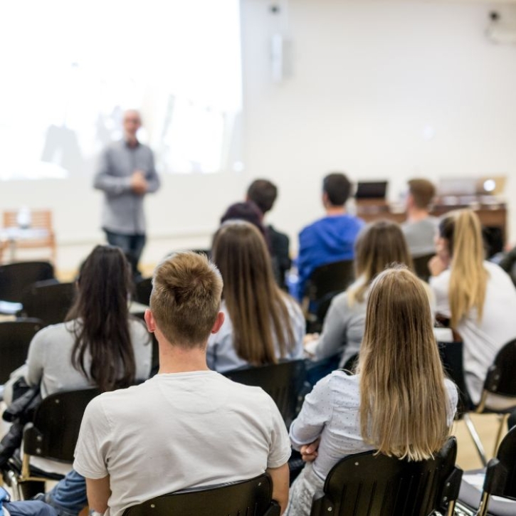 Student watch a lecturer giving a presentation