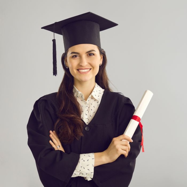 A student stands and smiles