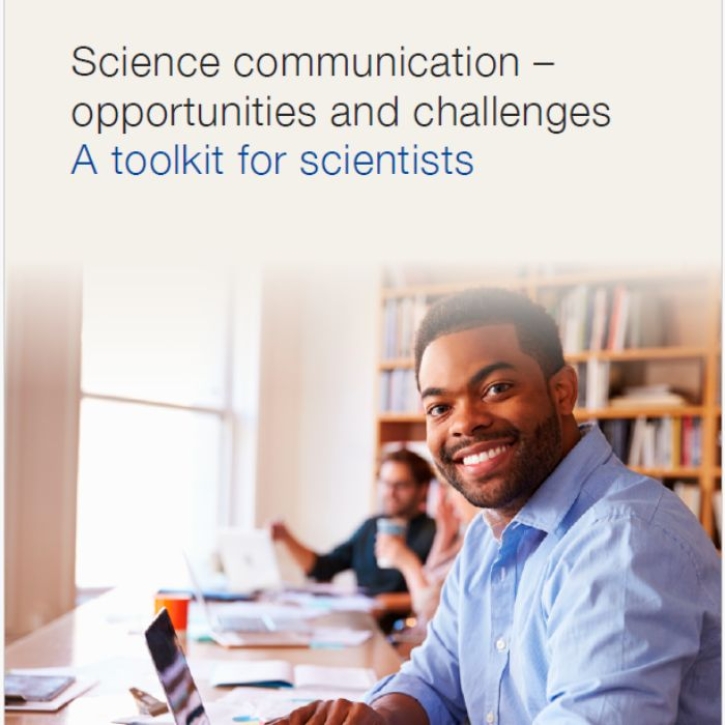 A man in a library smiles