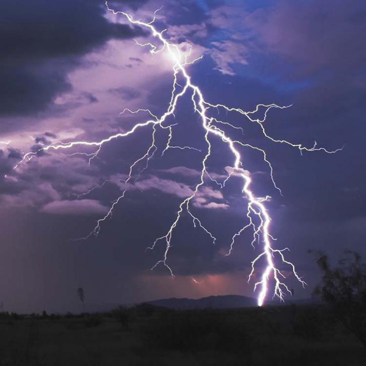 Lightning in front of a purple sky