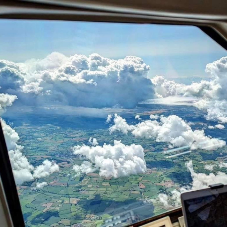 Image of clouds through the window of an aircraft