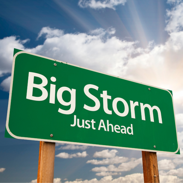 Image of a green sign with the wording "big storm just ahead" in front of a cloudy sky
